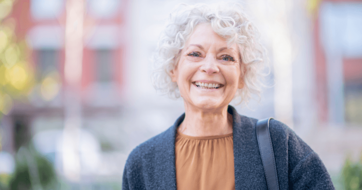 A woman is happy thanks to following good senior incontinence management practices.