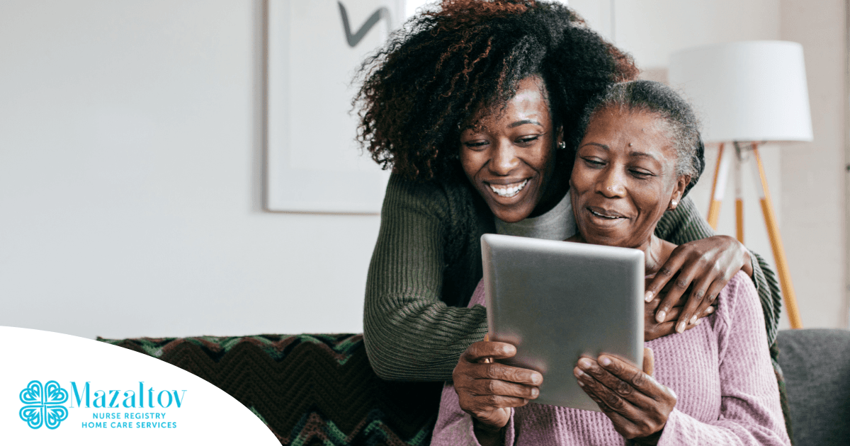 A caregiver helps a senior with her tablet, representing the rise of technology in home care.