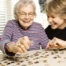 caregiver playing puzzles with elderly