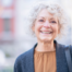 A woman is happy thanks to following good senior incontinence management practices.
