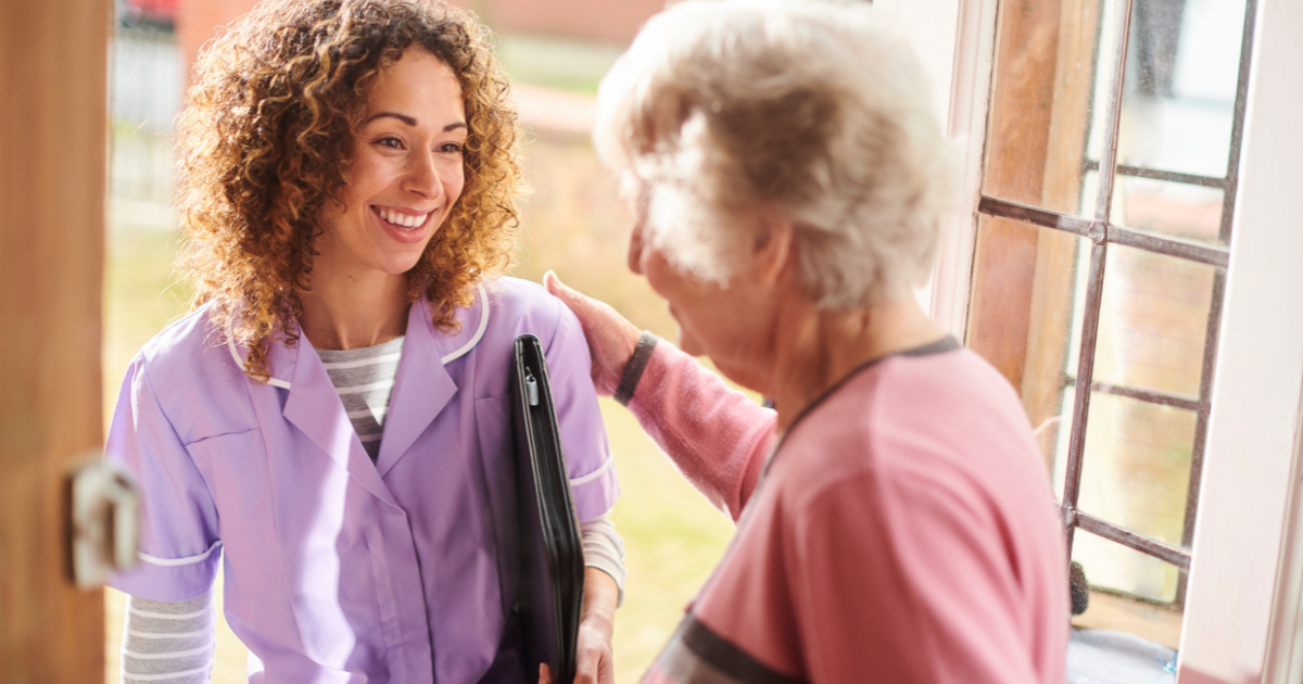 A caregiver greets a client at home and prepares to provide respite care.