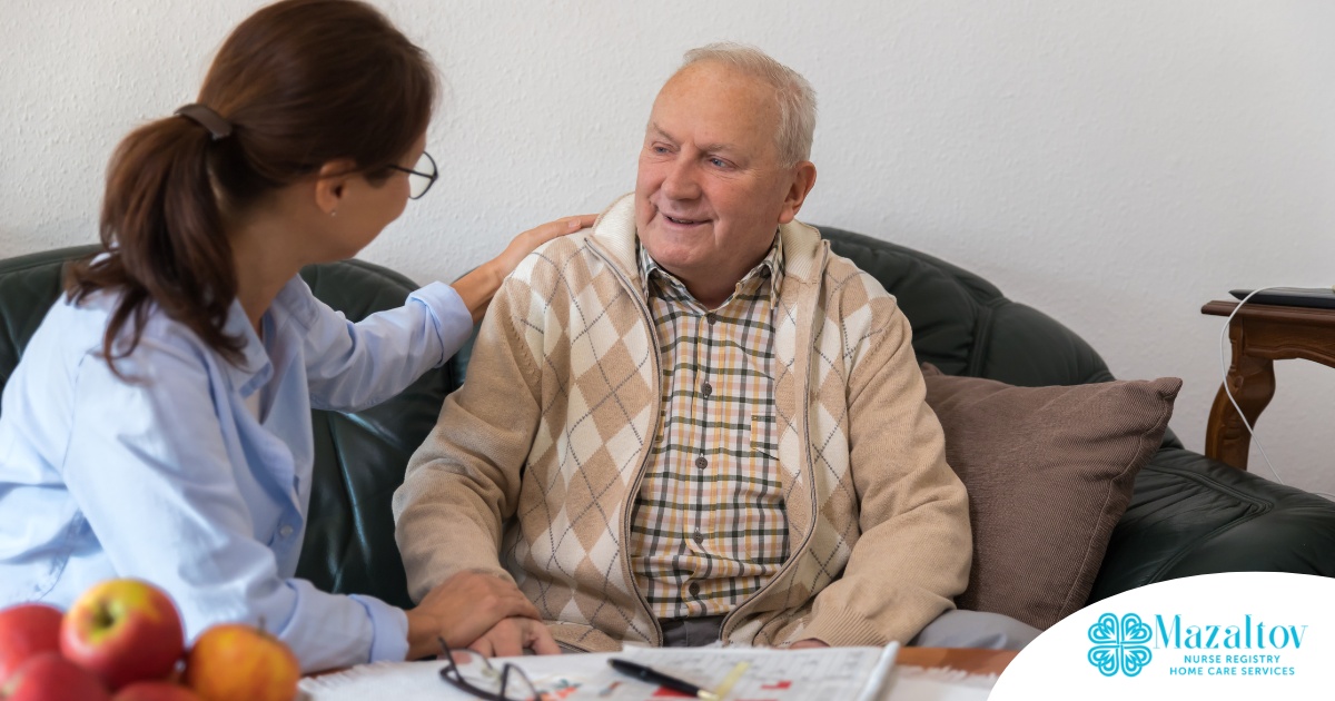 A caregiver compassionately listens to an older man, representing the kind of patience and empathy that help with communicating with clients who have dementia.